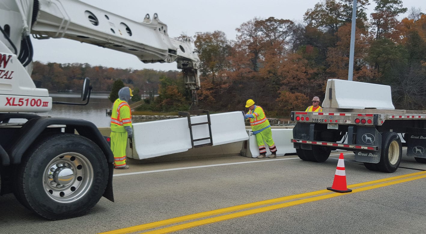 Installing J-J Hooks safety barriers on a roadway